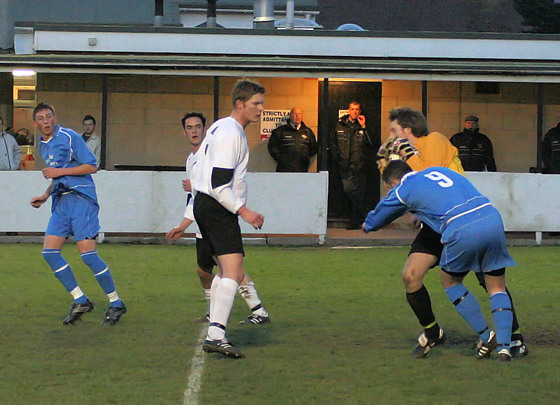 Neil Gledhill stops Jason Chandler getting the ball, with James Davies watching closely

