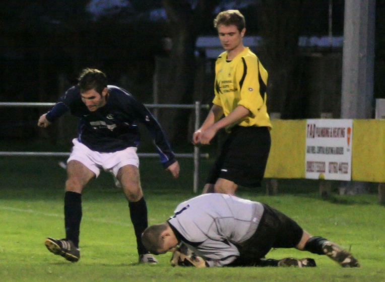 Jon Hendrick grabs the ball at the feet of Chris Ransome
