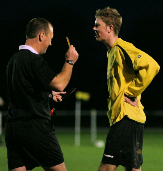 Dan Swain gets a yellow card from referee Barrie Small
