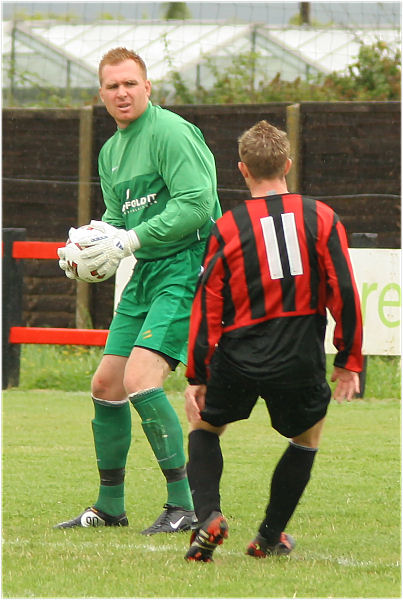 Ross Standen collects the ball with Danny Curd running in
