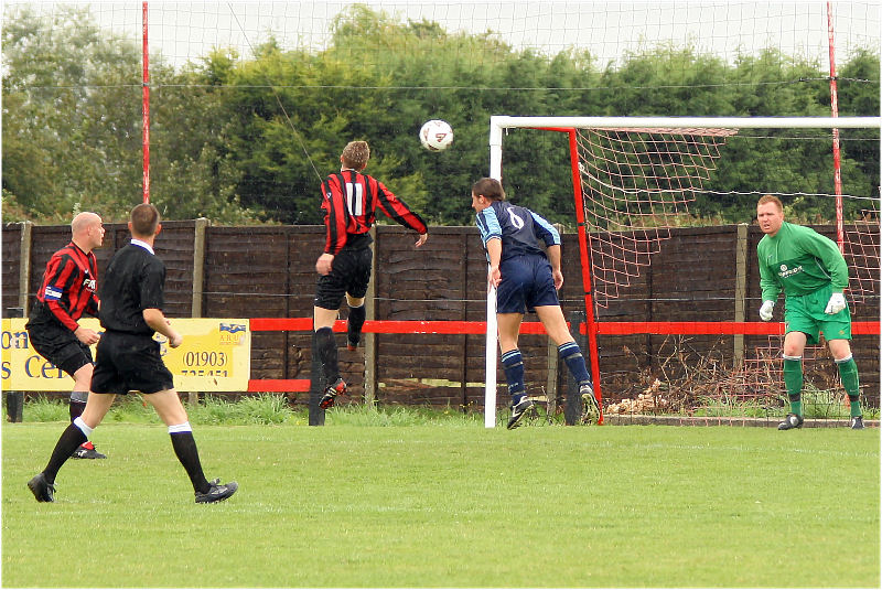 Danny Curd and Gary Stacey go for the header
