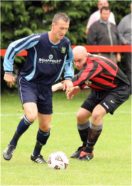 Julian Curnow on the ball with Tony Miles
