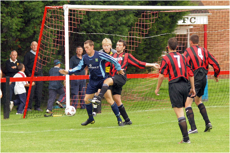 Ollie Howcroft nicks the ball away from Clinton Moore
