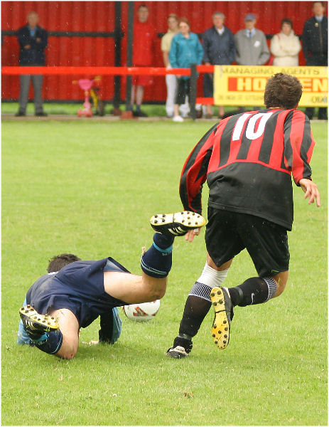 Dominic Shepherd (?) goes down as Tom Manton breaks away
