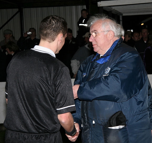 Referee Ryan Ellis picks up his medal
