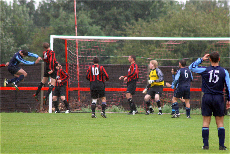 A Ringmer player jumps high with Wick's Paul Hodder

