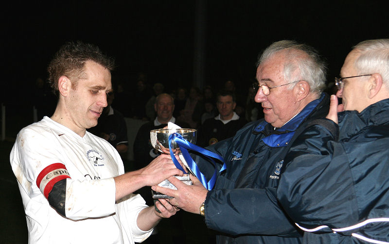 Storrington captain Matt Bridle is presented with the cup by Peter Bentley ...

