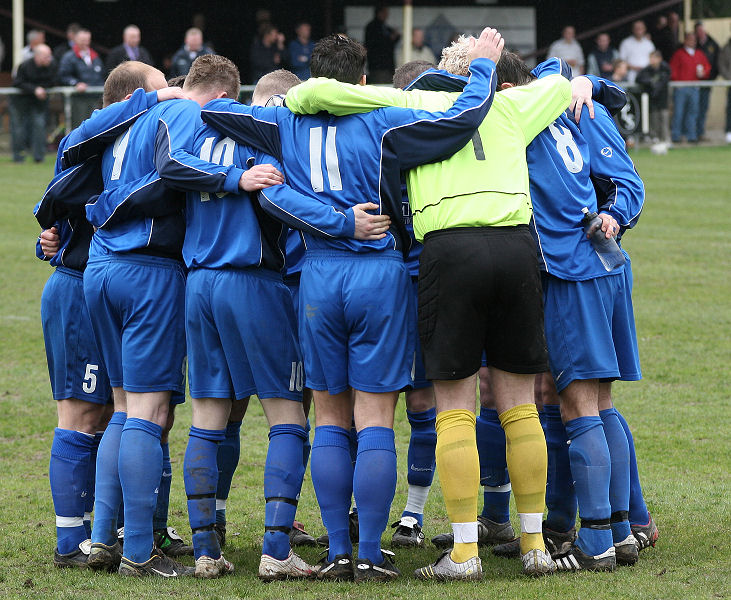 The Rustington team go into their pre-match huddle
