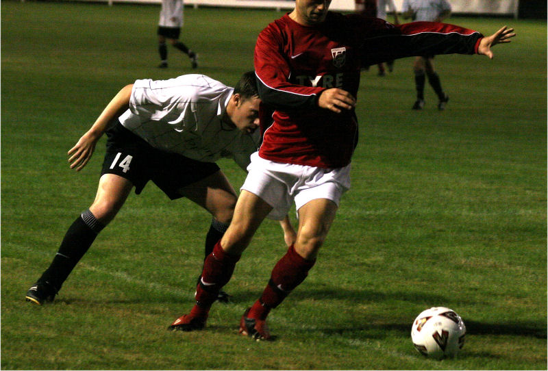 Stuart Bennett (14) keeps a close watch on Marcus Farrell (?)
