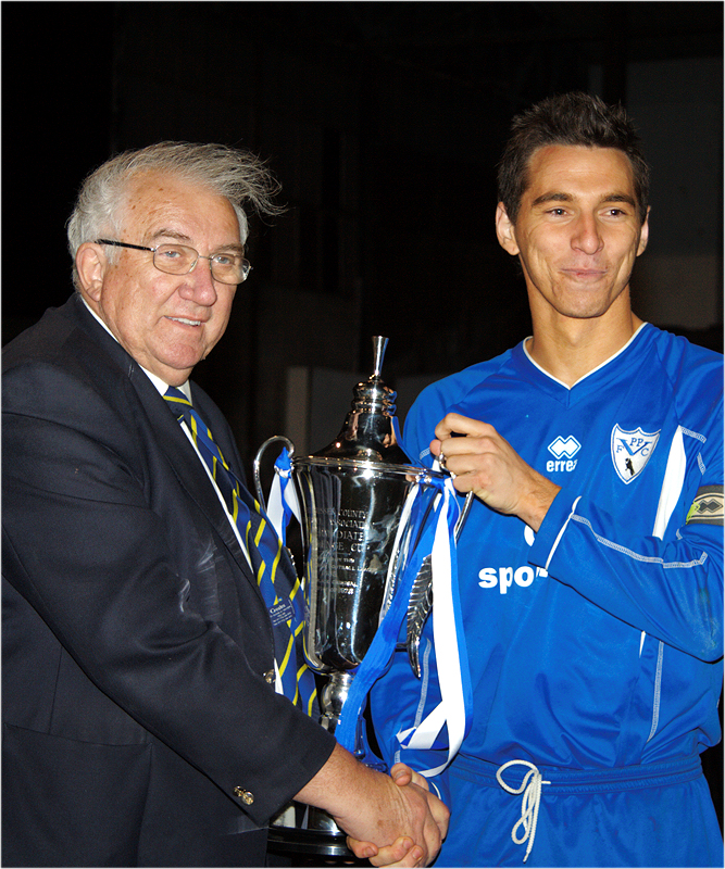 Pottage Captain Carl Dunk receives the Sussex Intermediate Challenge Cup from Peter Bentley
