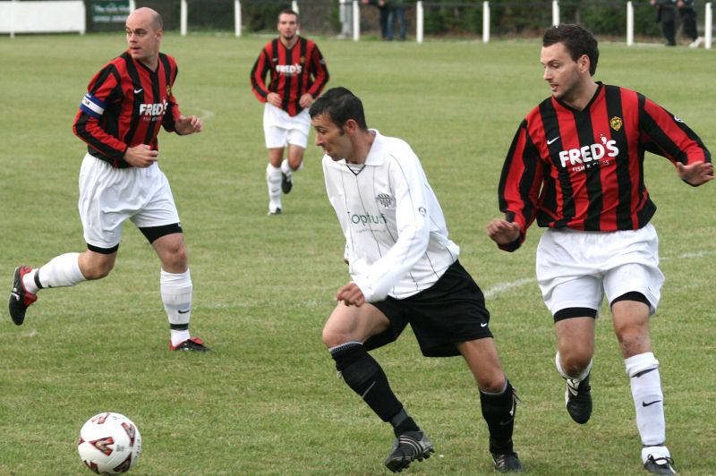 Phil Churchill on the ball with Ollie Howcroft closing in
