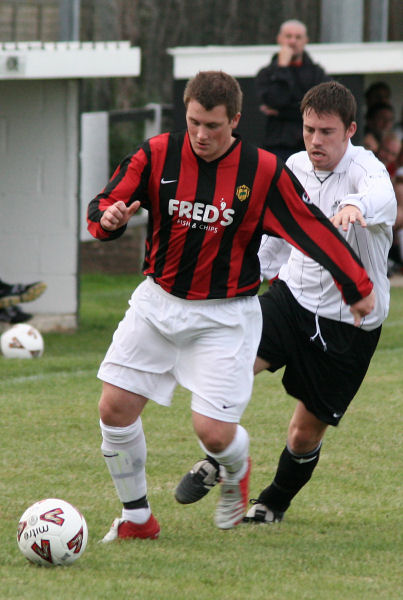 Lee Howard brings the ball away from Stuart Bennett
