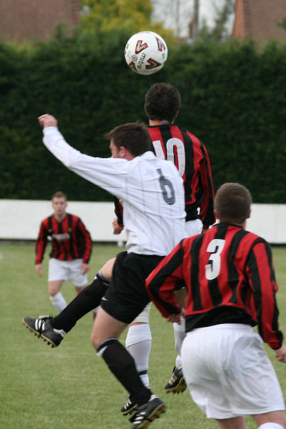 Tom Manton (10) and Stuart Bennett (6) go for a header watched by Lee Howard (3)
