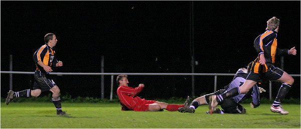 Eamonn Searle's shot is blocked by Stuart Robinson
