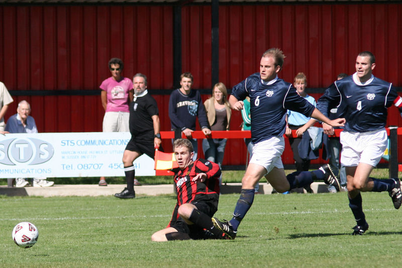 Danny Curd gets his shot away from Jon Tucker (6) and Jim Smith (4) ...
