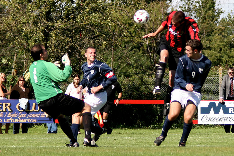 Chris Morrow climbs high above Dave Walker for this header ...
