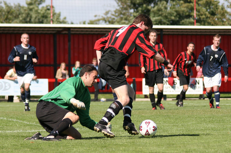 Adam Burton tries to bring the ball round Ben O'Connor
