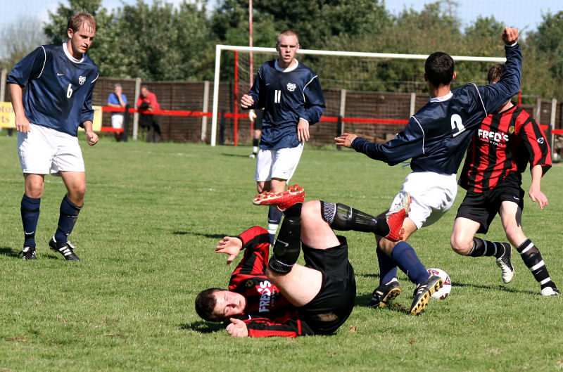 Lee Howard takes a tumble as he tries to beat Darren Akmenkalns (2) with Jon Tucker (6), Lee Barnard (11)  and Adam Burton close up
