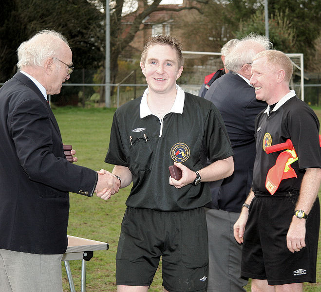 Referee Danny Austin receives his memento from Peter Strange
