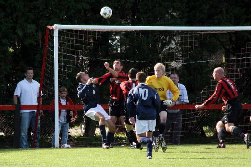 Arundel build the pressure and Jim Smith (4) and Chris Morrow go for the ball
