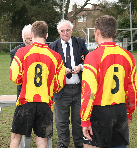 Lingfield players Bradley King and Steven Moore collect their runners-up medals from Peter Strange and Peter Bentley 
