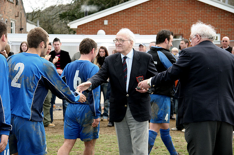 Sean Duffy and the Rustington team collect their winners medals from Peter Strange and Peter Bentley 
