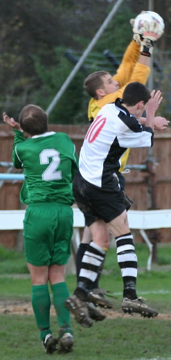 Simon Lehkyj grabs the ball challenged by Michael Frangou
