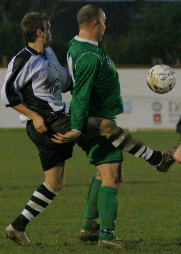 Tim Lester tries to hook the ball away from Mark Enticknap
