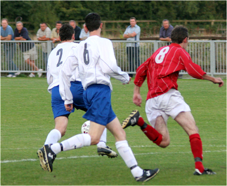 Ollie Howcroft (2) and Dave Sharman (6) keep a close watch on Andy Boxall (8)
