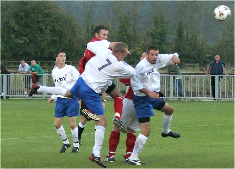 Dave Walker gets a header in challenged by Paul Hodder (7) and Chris Morrow
