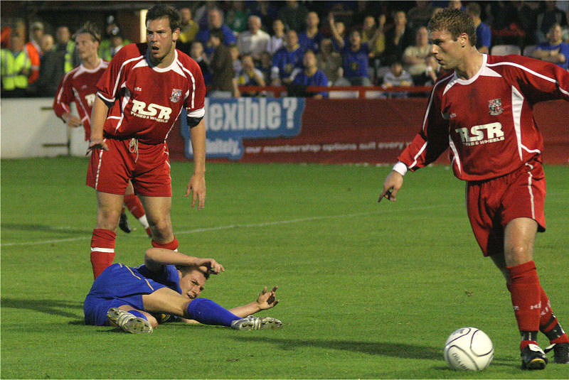 Craig Carley hits the deck as Mark Willy clears the ball
