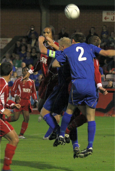 Steve Butler and 'Frankie' Howard both go for a header
