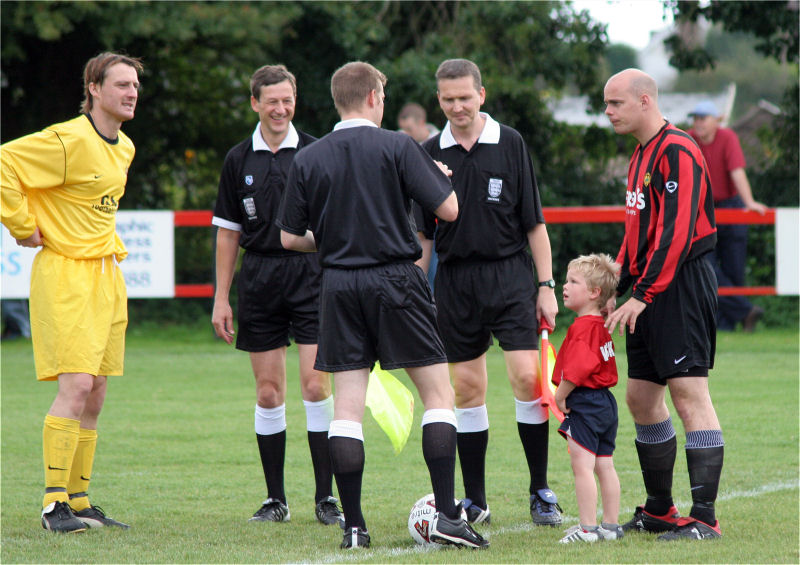 Captains Marc Cable and Tony Miles meet with the officials with match mascot Tony's son Andrew
