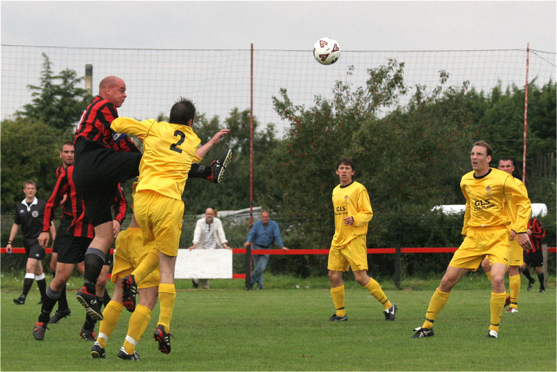 Tony Miles beats Andy Lutwyche to a header which goes just wide 
