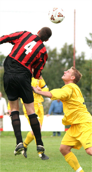 Chris Morrow (4) heads away from Mark Knee
