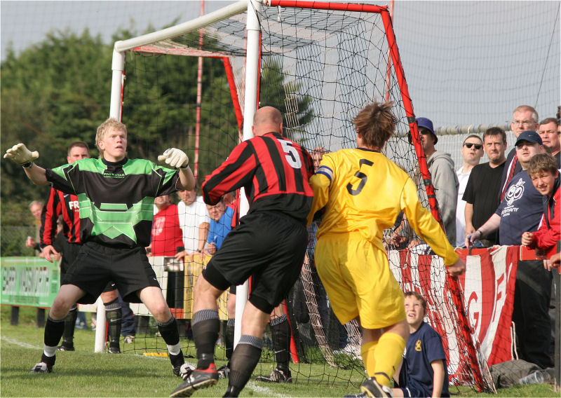 Captains Tony Miles and Marc Cable battle it out as Tom Rand waits for the ball to drop
