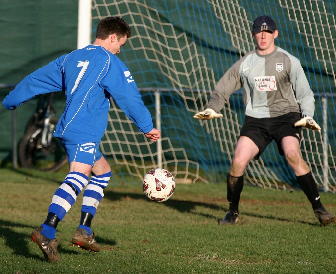 Ryan Morten tries a shot on goal ...
