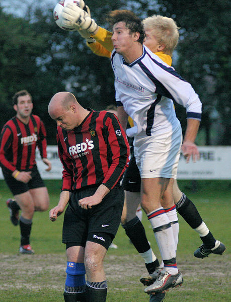 Tom Rand gets to the ball before Liam O'Brien with help from Tony Miles ...
