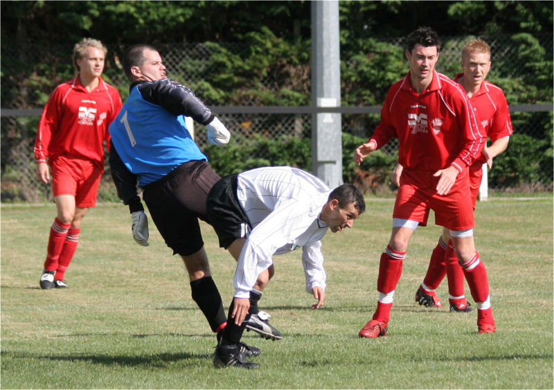 Phil Churchill tangles with Redhill keeper Chris Roberts
