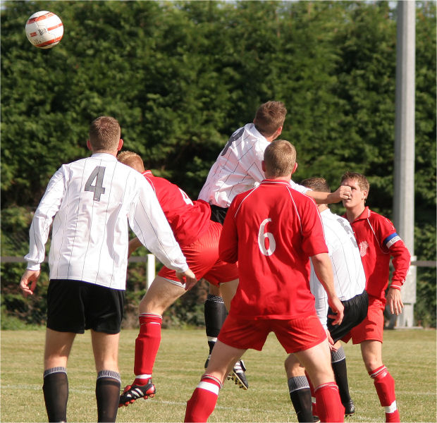 James Bennett (8) and Stuart Channon go for a header
