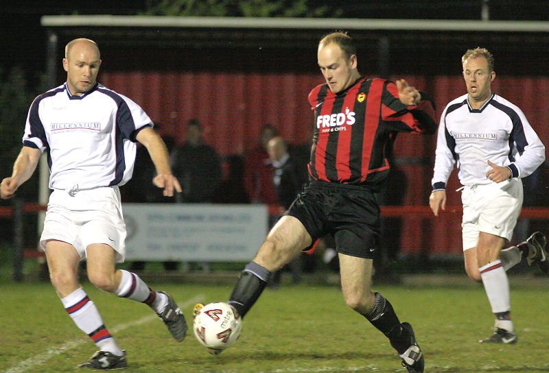 Darren Annis on the ball watched by Steve Pickles
