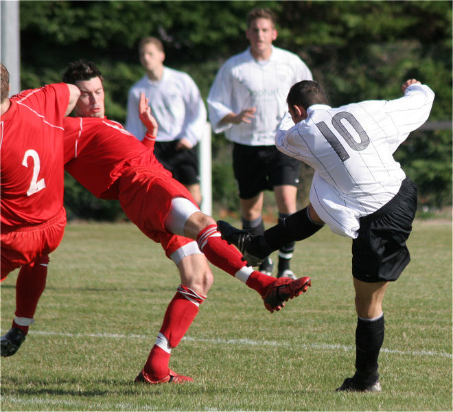 Phil Churchill (10) gets a shot in
