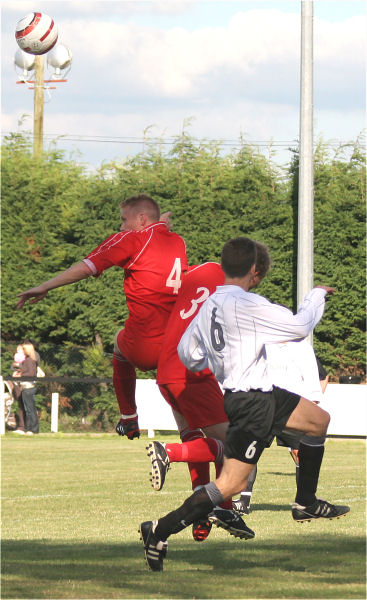 Stuart Channon (4) clears as Jamie Still (3) fends off Chris Yelling (6)
