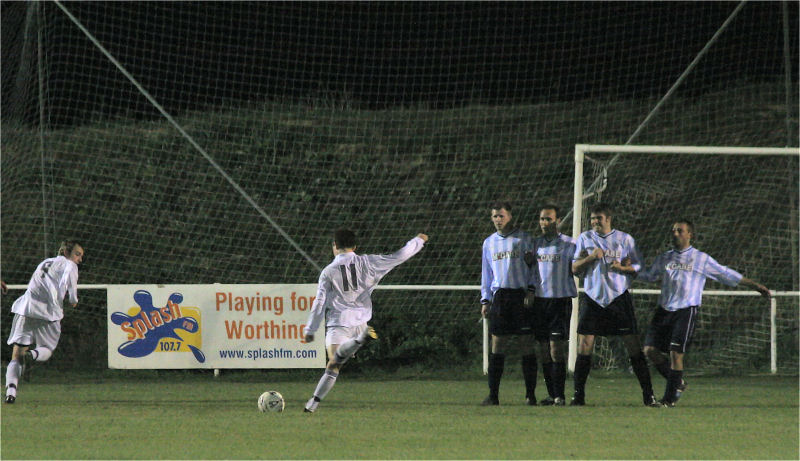 Matt Axell curls his free kick ...
