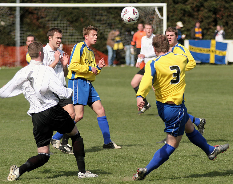 Carl Harris clears away from Dan Swain 
