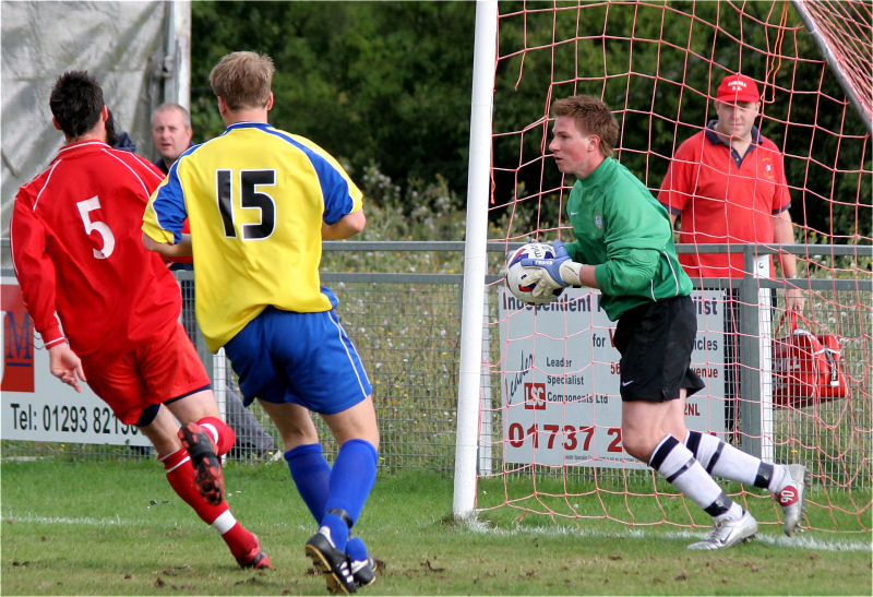 Keeper Phillip Bowald collects from Danny Guscott (5) watched by Sheldon Snashall
