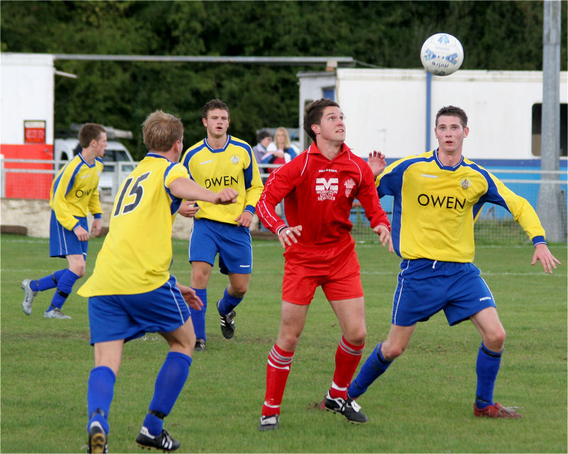 Sheldon Snashall (15) watches as the ball drops beween Chad Heuston and Tom Rowe
