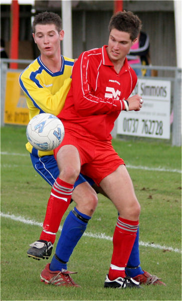 Chad Heuston shields the ball from Tom Rowe ...
