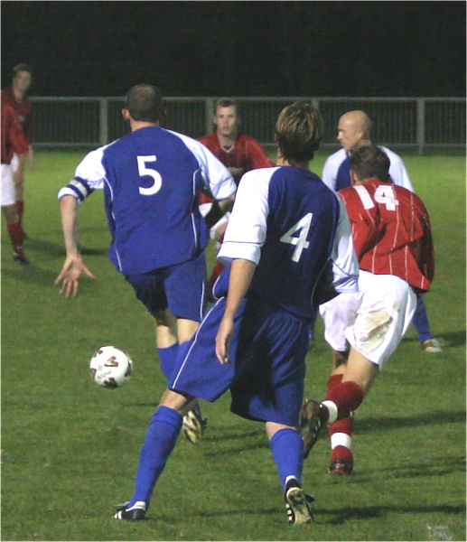 Whitehawk captain Andy Beech (5) clears the ball watched by Aaron Gunn (4) and Gary Norgate (14)
