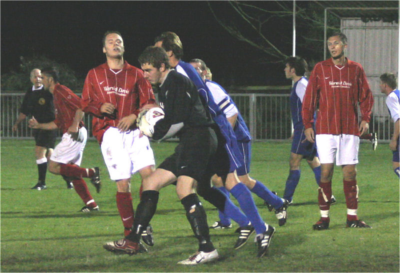 Whitehawk keeper Michael Hunter gathers under pressure from Matt Huckett
